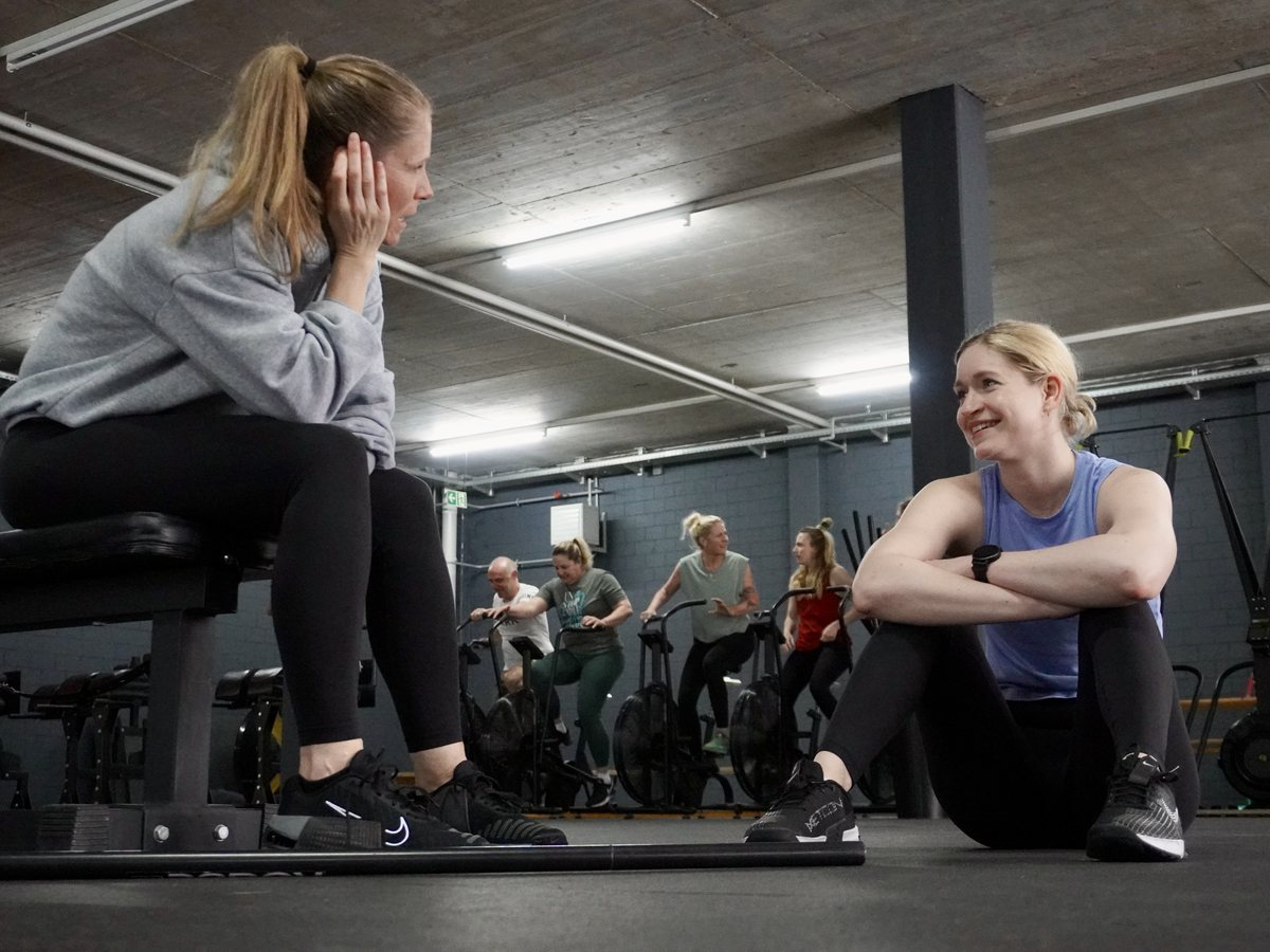 Two members talking between sets at 1352 Athletics